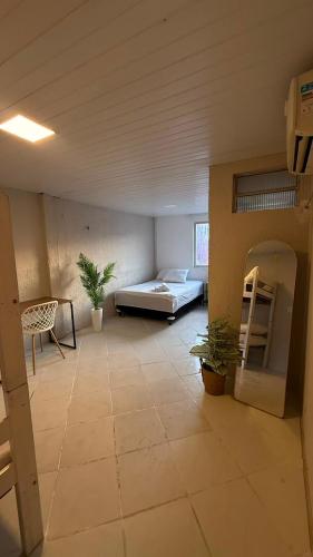 a room with a bed and a table and a couch at Brisa Mar in Fortaleza