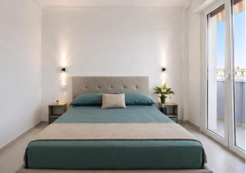 a bedroom with a large bed and a large window at Mellini Living in Misano Adriatico