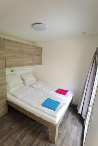a bed with two towels on it in a room at Forest house Maestral in Koper
