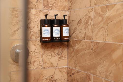 a bathroom with two bottles of soap on a wall at Costa Catalina in Santa Catalina
