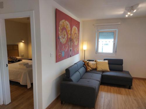 a living room with a couch and a bed at Sweet Hill Bilbao in Bilbao