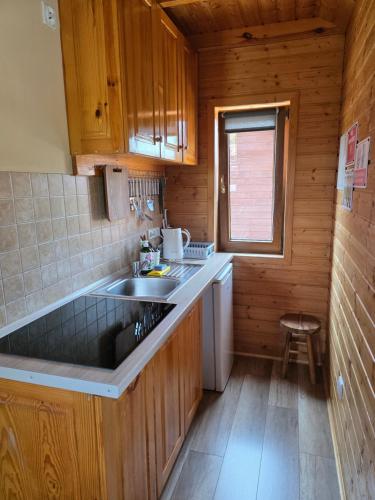 a kitchen with a sink and a counter top at Na Równej Bieszczady in Polańczyk