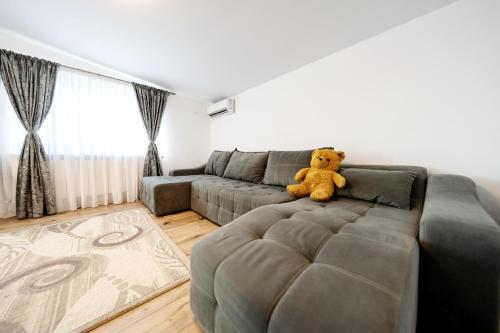 a teddy bear sitting on a couch in a living room at Casa Agigea in Agigea