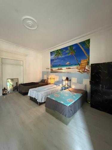 a bedroom with two beds and a painting on the wall at Ferienzimmer Healing und Montuerwohnung in Weißenfels