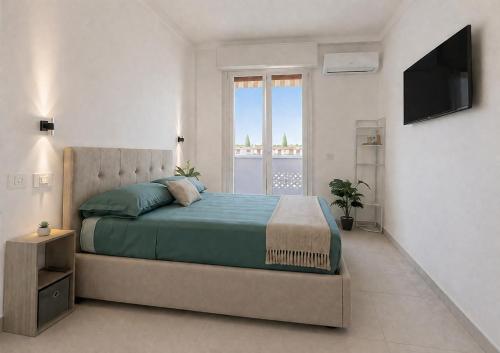 a bedroom with a large bed and a window at Mellini Living in Misano Adriatico