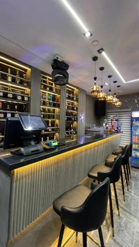 a bar with a row of chairs and a counter at X-ones place command in Meran