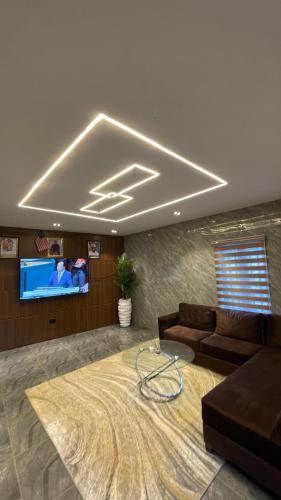 a living room with a couch and a flat screen tv at X-ones place command in Meran