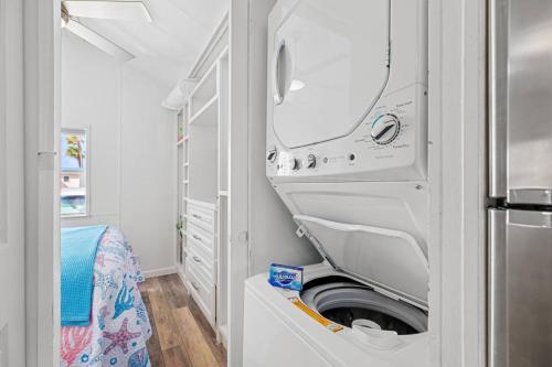 a kitchen with a washer and dryer in a room at Bonnet Sea Cottage on the water- LIV Resort in Port Isabel