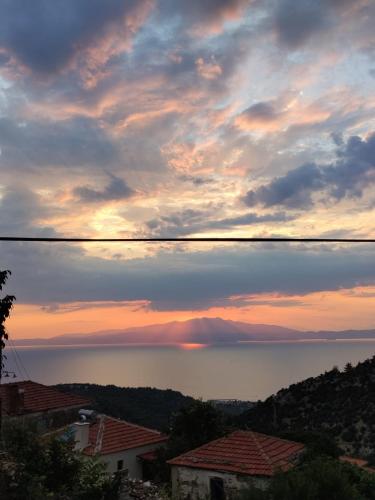 a view of the ocean at sunset at Perfect View House in Sotír