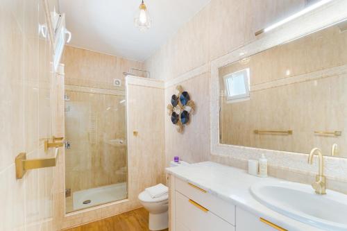 a bathroom with a sink and a shower and a toilet at New Horizon Algarve in Almancil