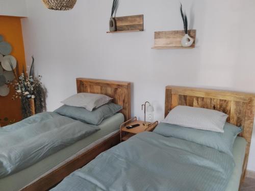 two beds sitting next to each other in a bedroom at Apartmán pod hradom B in Trenčín