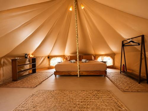 a bedroom with a bed in a tent at Shamalay - Nomad Experience in Bacalar