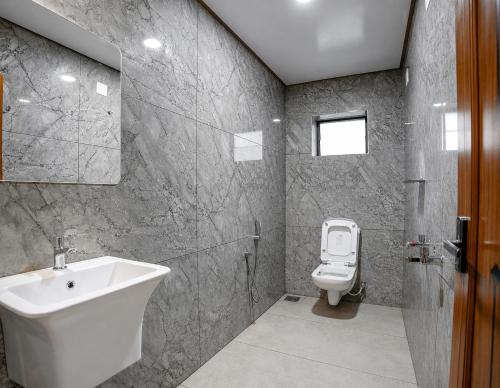 a bathroom with a sink and a toilet at Lake Residency Ooty in Ooty
