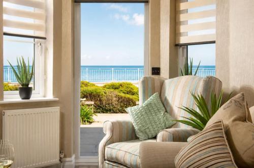 a living room with a couch and a view of the ocean at Crystal View by the Sea in Carbis Bay