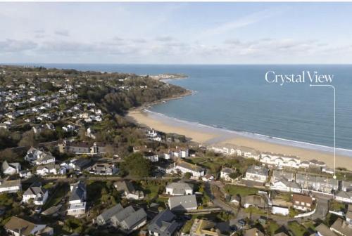 an aerial view of a beach with houses and the ocean at Crystal View by the Sea in Carbis Bay