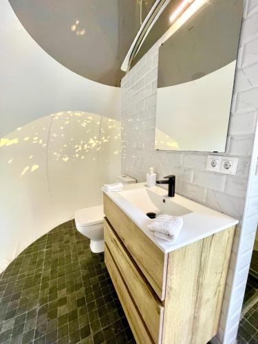 a bathroom with a sink and a toilet at Fuente del Lobo Glamping & Bungalows - Adults Only in Pinos Genil