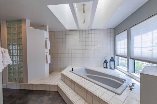 a large bathroom with a tub and a window at Hilltop Oasis in Templeton