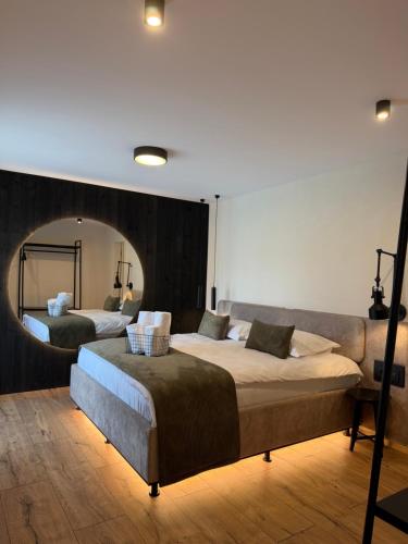 two beds in a room with a mirror at Akacia Chalet in Moieciu de Jos
