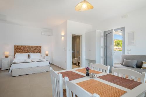 a bedroom and living room with a bed and a table at Alsalos Villas in Amoopi