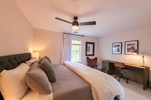 a bedroom with a large bed and a desk at Hilltop Oasis in Templeton