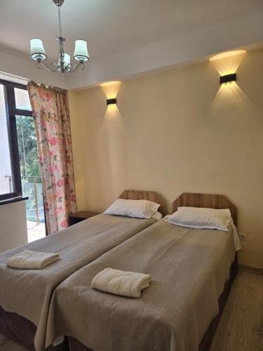 a bedroom with a large bed with two towels on it at Baytur-Yilla09 in Bosteri