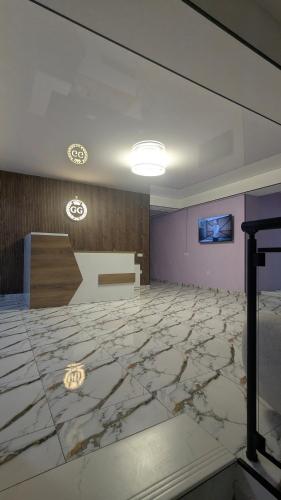 a large room with a marble floor and a wall at Hotel G&G in Tsaghveri