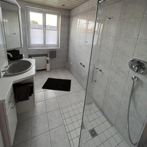a bathroom with a shower and a sink at Casa-Heckl in Tutzing