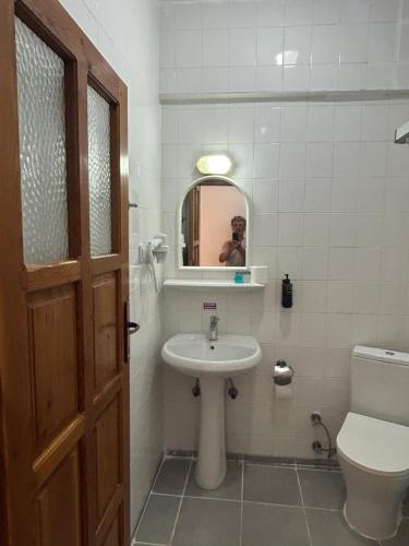 a bathroom with a sink and a toilet and a mirror at Ünlü Otel in Fethiye