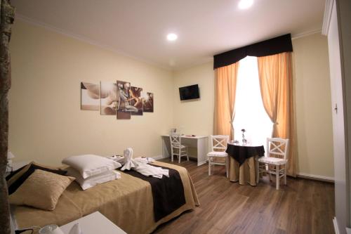 a bedroom with a bed and a table and a window at Freedom Love B&B in Rome