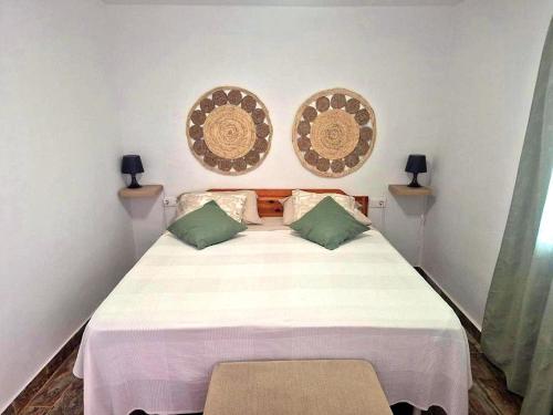 a bedroom with a large bed with two pillows at Luz del Mar in Órzola