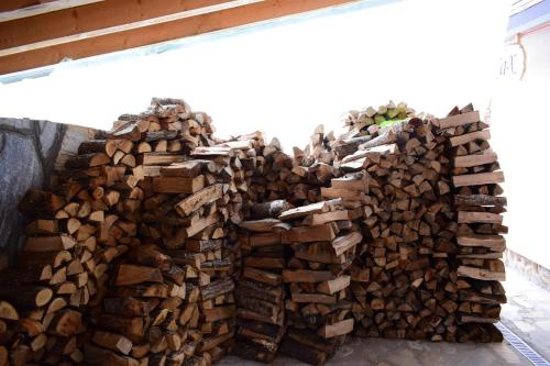 a pile of fire wood in a building at Holiday Home Relax in Kopaonik