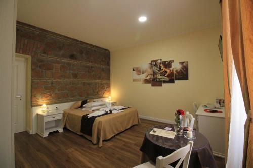 a bedroom with a bed and a brick wall at Freedom Love B&B in Rome