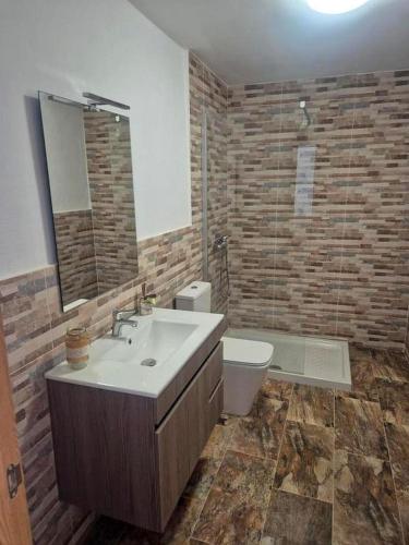 a bathroom with a sink and a toilet at Luz del Mar in Órzola