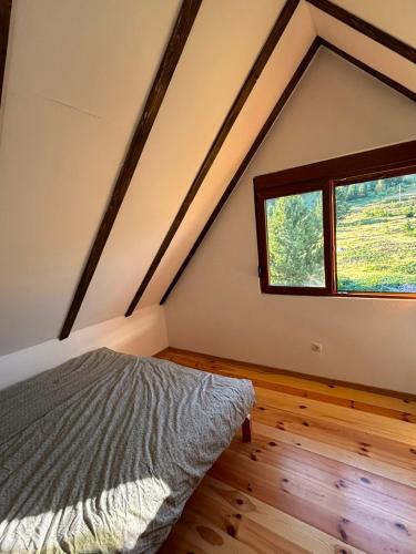 a bedroom with a bed and a large window at Gabriels7 in Korita