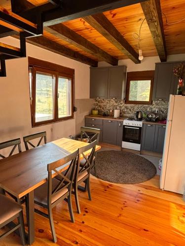 a kitchen with a table and chairs and a refrigerator at Gabriels7 in Korita