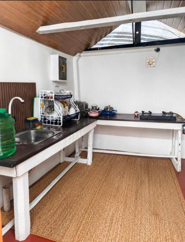 a kitchen with a counter top and a sink at Marari Red Angel in Mararikulam