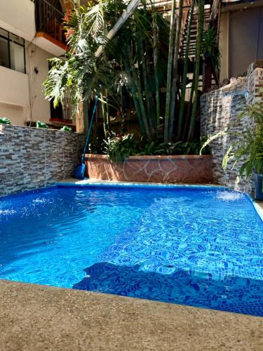 a large blue swimming pool in a building at Posada Temazcal Santo Domingo in Tepoztlán