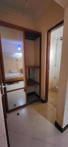 an empty room with an open refrigerator in a room at Tarakea Lodge in Mbuguni