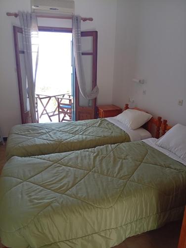 two beds sitting next to each other in a bedroom at Sevi - Irene Studios in Masouri