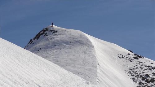 a snow covered mountain with a person on top of it at Appartements Gassner in Bruck an der Großglocknerstraße