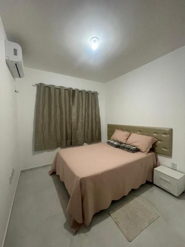 a bedroom with a bed and a window at Casa Aquiraz in Aquiraz