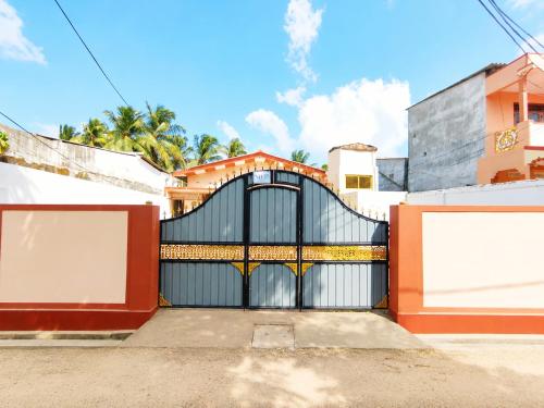 a gate in a driveway in front of a house at Yarl Retreat Villa - Non-AC in Jaffna