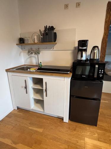 a small kitchen with a sink and a refrigerator at Fewo kleine Auszeit in Karbach