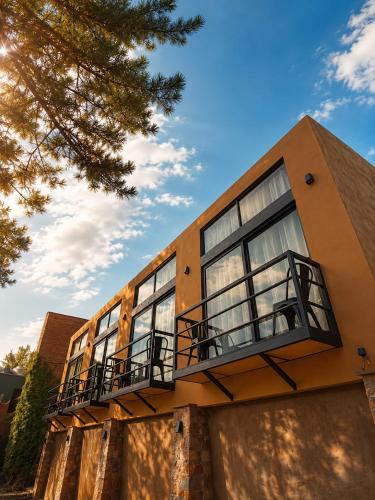 a building with windows and a balcony on it at Casona San Cayetano Suites & Lofts & Spa by SCE in Guanajuato