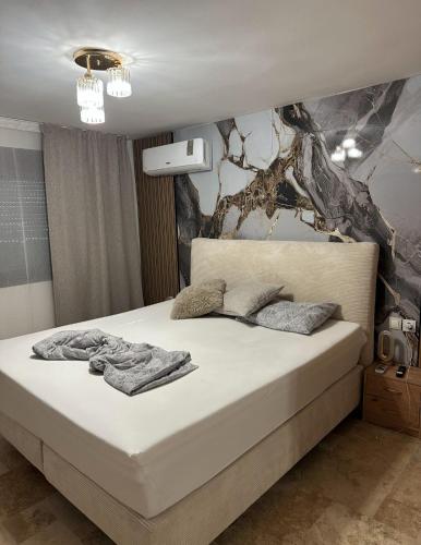 a bedroom with a bed with towels on it at Sofia Villa in Astris