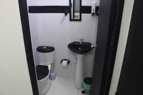 a small bathroom with a sink and a toilet at Hostal Monte Verde in Zaragoza