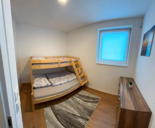 a bedroom with a bunk bed with a window at Apartmán Kutička in Prešov