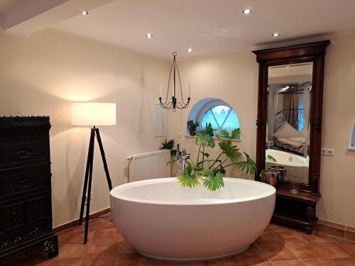 a large bath tub in a room with a lamp at Bleckmanns Hof in Werne an der Lippe