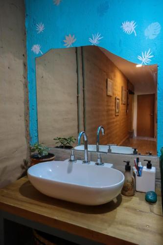 a bathroom sink with a large mirror above it at Marta Maria in El Rodeo