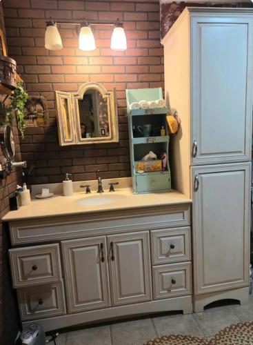 a bathroom vanity with a sink and a mirror at George School Garden Homestay in Langhorne